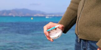 a man is holding a toothbrush in his hand