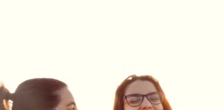 woman in black tank top beside woman in white tank top