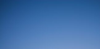 man and woman holding hands in silhouette photography