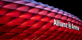 a large red building with a sign that says allianz arena