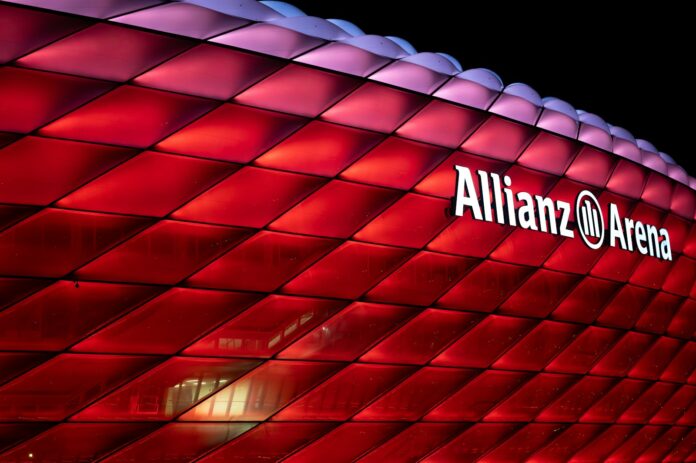 a large red building with a sign that says allianz arena