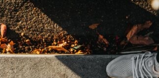 smiley paint on gray ground in front of people