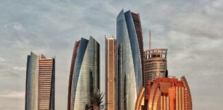 green grass field near high rise buildings during daytime