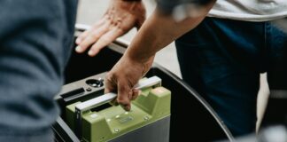 person holding black and green electronic device