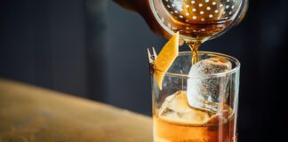 liquor pouring on clear shot glass