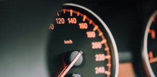 closeup photo of black analog speedometer