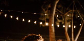 man kissing woman's forehead