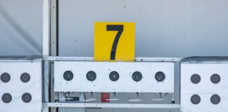 a number seven sign on top of a metal structure