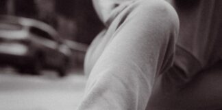 person wearing black and white nike sneakers