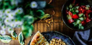 silver spoon on black ceramic bowl with vegetables