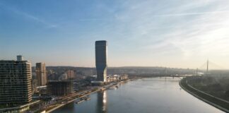 a river running through a city next to tall buildings