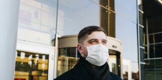 man in black robe wearing white face mask