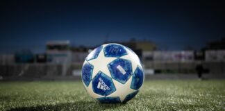 white blue soccer ball on green grass field during daytime