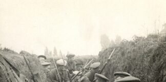 a group of men sitting next to each other in a trench