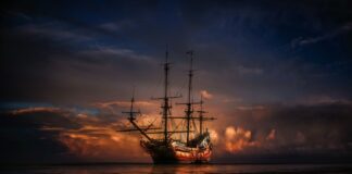 brown ship on sea during sunset