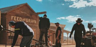 four men standing outside Feed and Grain store