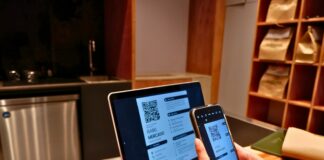 a person using a laptop and a cell phone