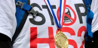 person wearing round gold-colored medallion