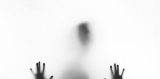 person behind fog glass