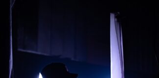 silhouette of man carrying camera