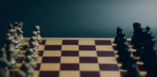 a close up of a chess board with pieces on it