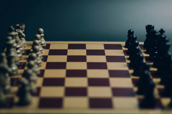 a close up of a chess board with pieces on it