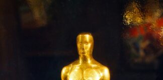 An oscar statue on display in a glass case