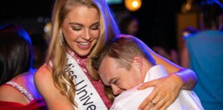 woman in white sleeveless shirt hugging man in white dress shirt