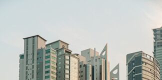 a group of tall buildings next to a body of water