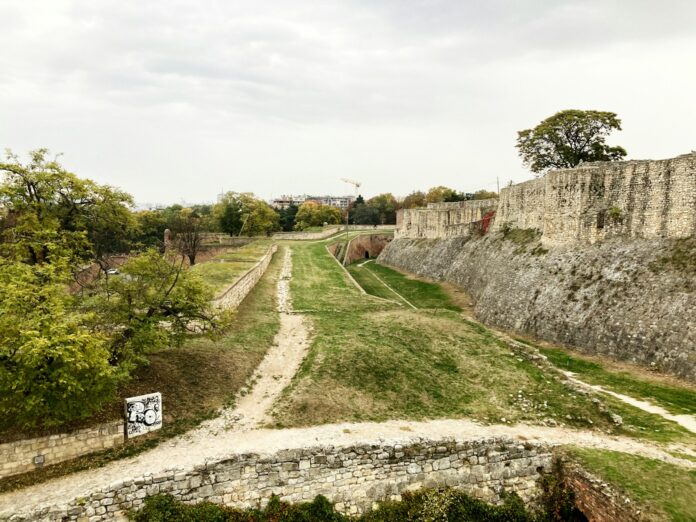 a stone wall with a sign on the side of it
