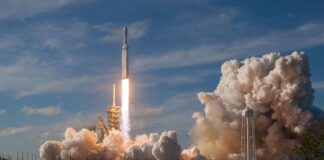 gray spacecraft taking off during daytime