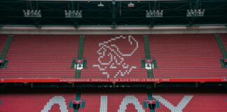 a soccer stadium with a red and green field