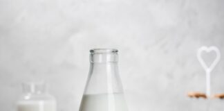 a bottle of milk and some cookies on a table