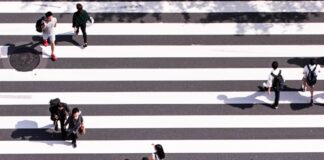 aerial view photography of group of people walking on gray and white pedestrian lane