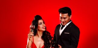 a woman in a red dress and a man in a black suit
