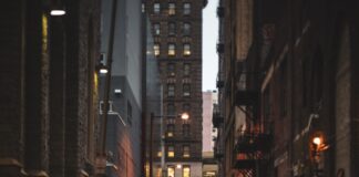 a city street with puddles of water on the ground