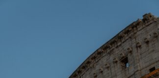 a very tall building with a clock on it's side