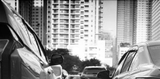 grayscale photo of cars on road