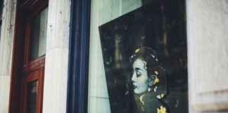 a picture of a woman's face is seen through a window
