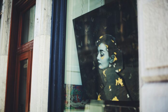 a picture of a woman's face is seen through a window