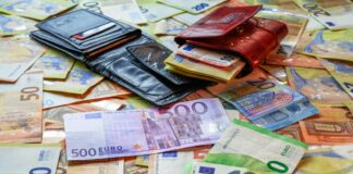 a pile of money sitting on top of a table