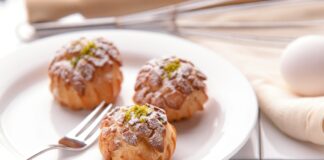 three pastries on ceramic plate with fork