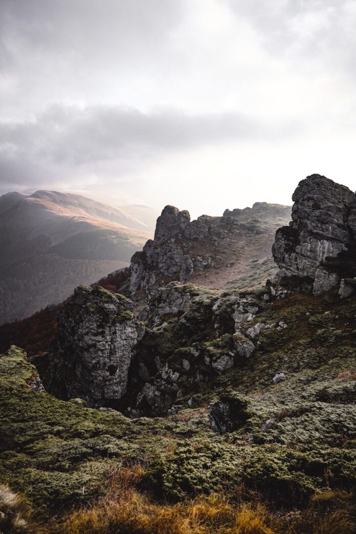 a person standing on top of a rocky hill