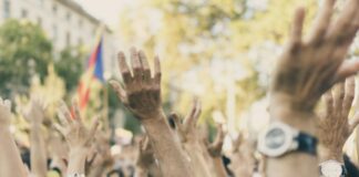 group of people raising their hands
