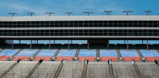 aerial photography of car on stadium under clear blue sky