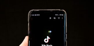 black android smartphone displaying 12 00