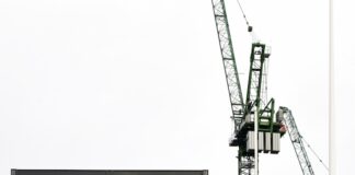 a crane is standing in front of a building