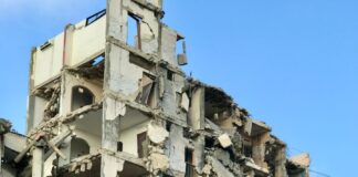 A very large building that has a bunch of rubble on it