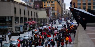 a crowd of people walking on a street