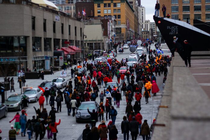 a crowd of people walking on a street